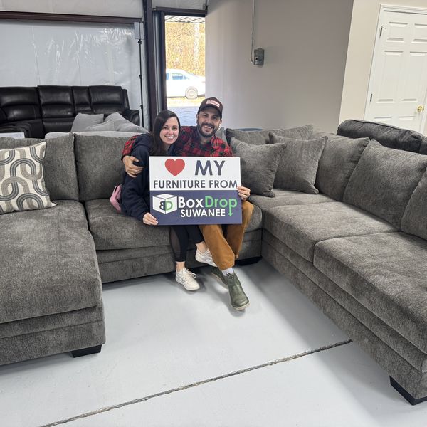 A couple with their new charcoal sectional at BoxDrop Suwanee