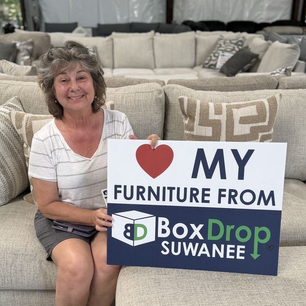 A customer with her new sofa at BoxDrop Suwanee