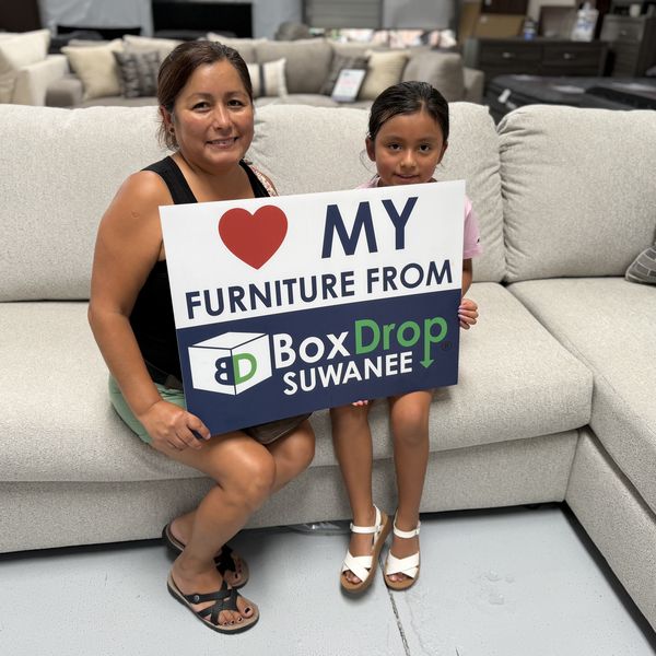 A mother and daughter with their new sectional at BoxDrop Suwanee