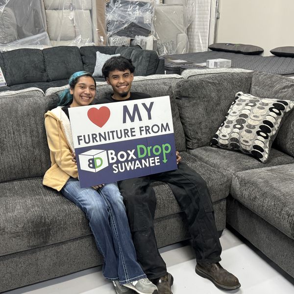A family with their new sectional at BoxDrop Suwanee