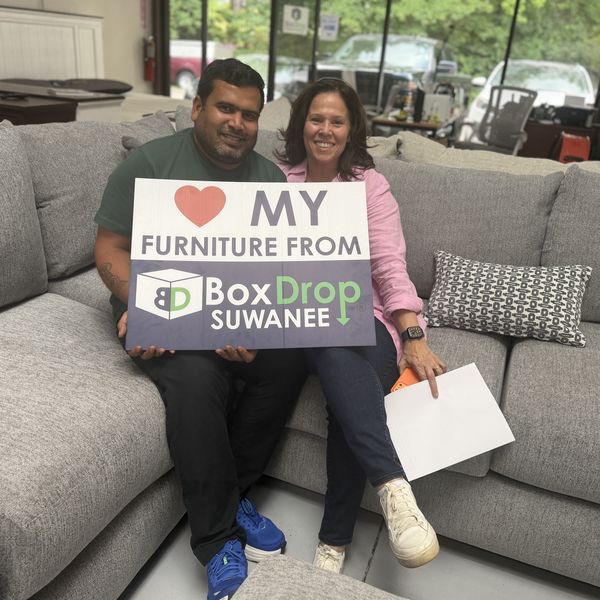 A couple trying out a new sectional at BoxDrop Suwanee