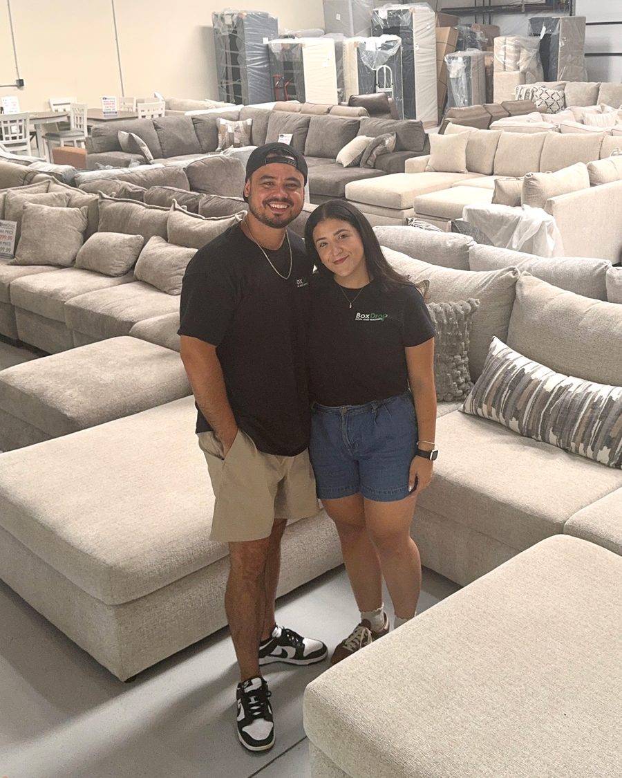 The owners of BoxDrop Suwanee standing on the warehouse floor